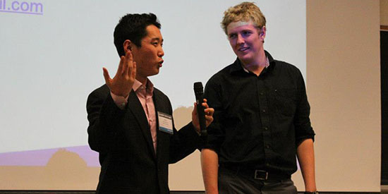 A photo of me pitching at the Queen's Startup Summit